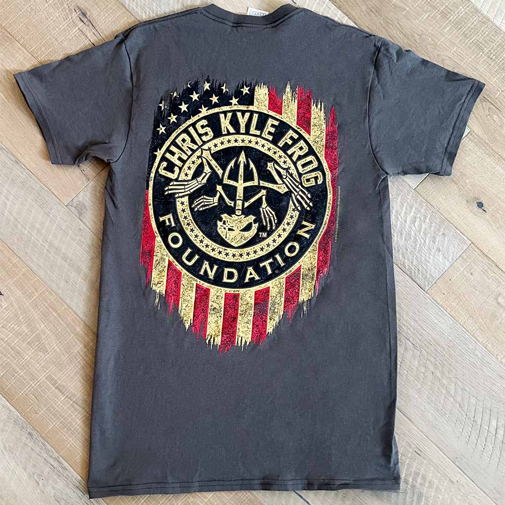 Back of grey shirt with round Chris Kyle foundation logo on rustic American flag