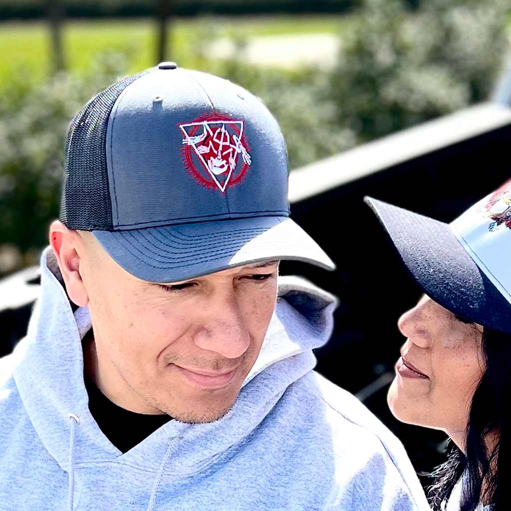 Man wearing grey and black snapback hat with red circle and white bone frog graphic