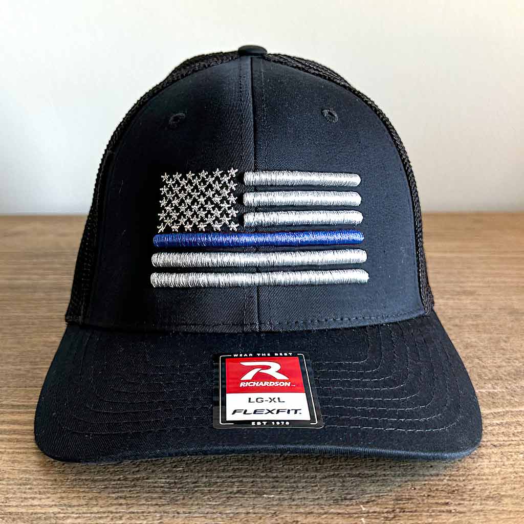 Black hat with an embroidered grey American flag with one blue line