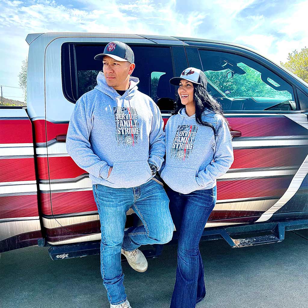 Couple wearing matching grey service family strong hoodies