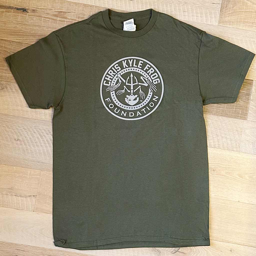 Chris Kyle Frog foundation circle bone frog logo in white on a olive green shirt
