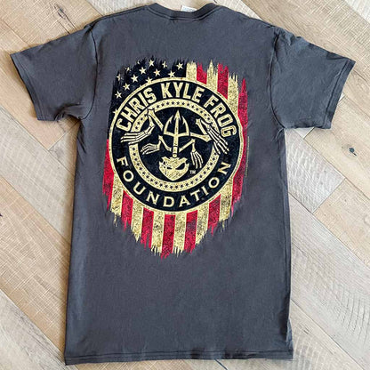 Back of grey shirt with round Chris Kyle foundation logo on rustic American flag 