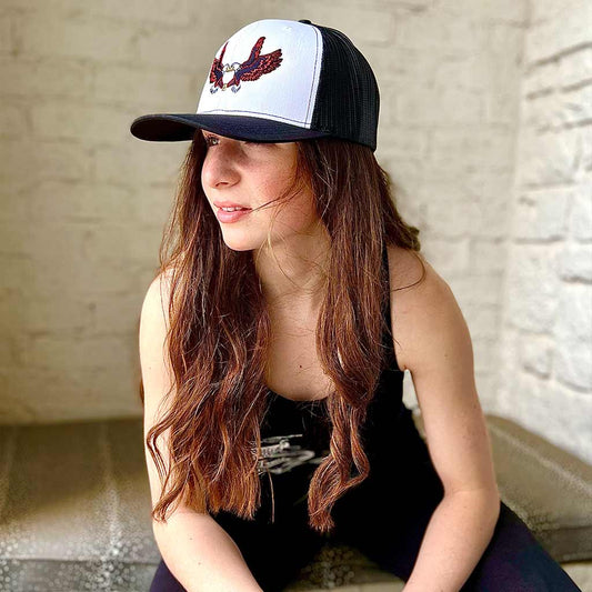 woman wearing white and black snapback hat with two eagles